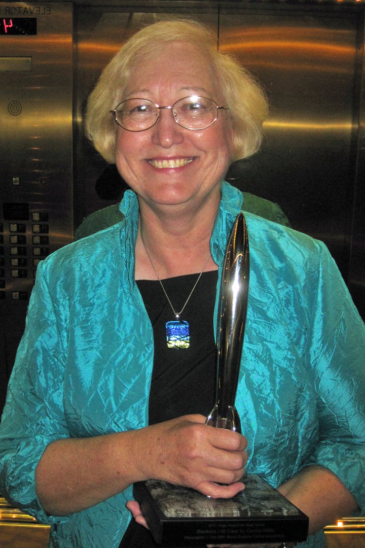 a photo of author Connie Willis holding one of her 11 awards